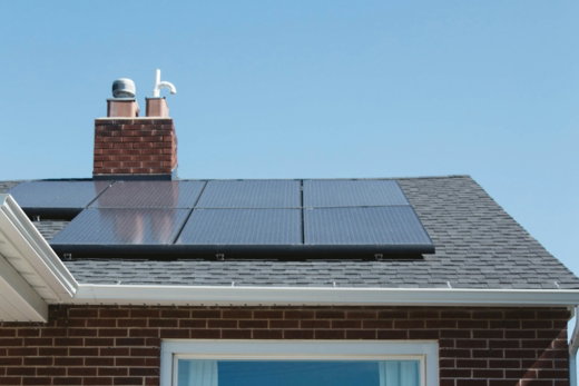brown brick house with solar panels on roof